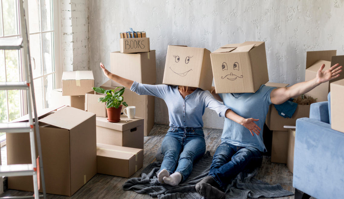 couple home moving day with boxes heads 1