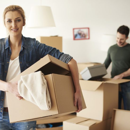 woman helping her boyfriend while moving house