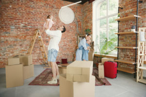 new life adult family moved new house apartment spouses children look happy confident moving relations new life concept unpacking boxes with their things playing together 1