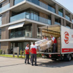 Professionelles Umzugsteam von SwissLogistik verlädt Möbel in Dietikon vor einem modernen Wohnhaus